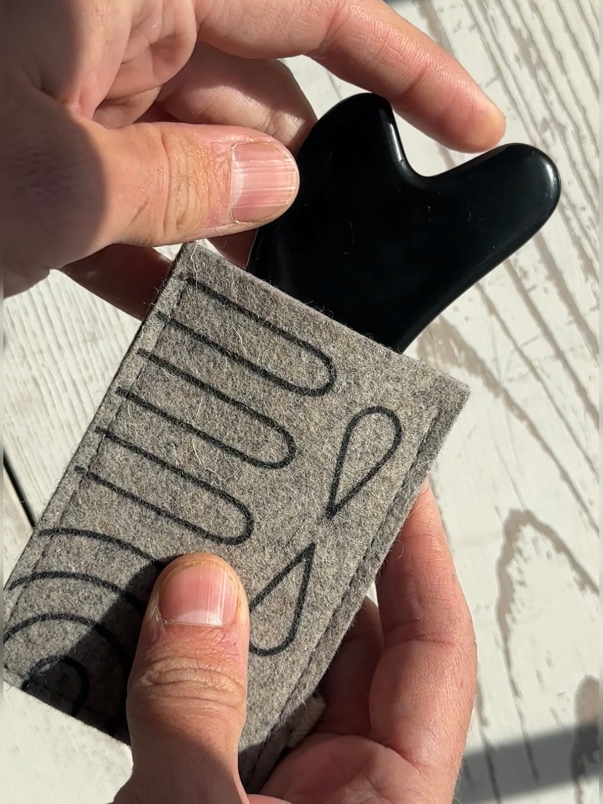 Video showing a gua sha tool sliding into the protector and then being removed.